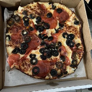 Downtown Chicago Pizza with pepperoni and black olives.