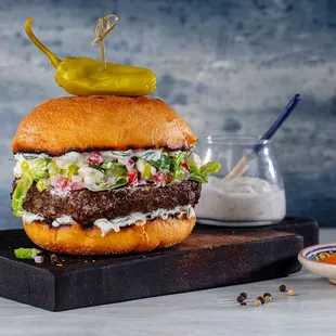 a burger with a pickle on top