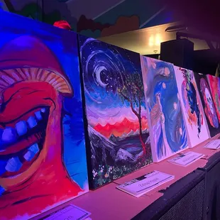 a row of paintings on a table