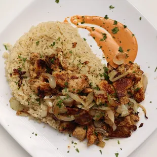 Chicken Shawarma Platter served with grilled onions over a bed of rice