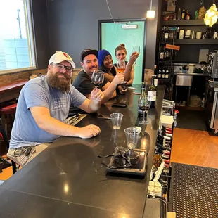 three men sitting at a bar