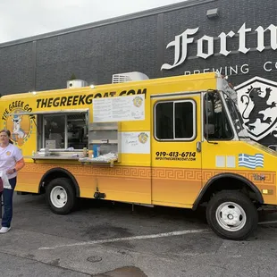 a woman standing in front of a food truck