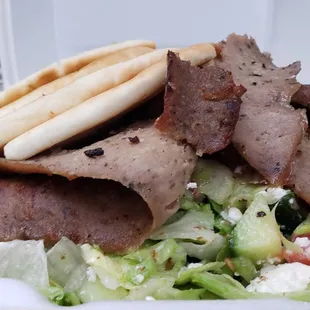 Greek Salad with Gyro Meat: Gyro Meat, Lettuce, Onion, Tomato, Cucumber, Feta Cheese, Kalamata Olives &amp; Greek Dressing, Served with Pita