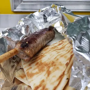 The Telly Savalas, &quot;Who Loves Ya, Baby&quot;: Greek (Loukaniko) Sausage, served on a skewer, with Tzatziki &amp; Pita Bread