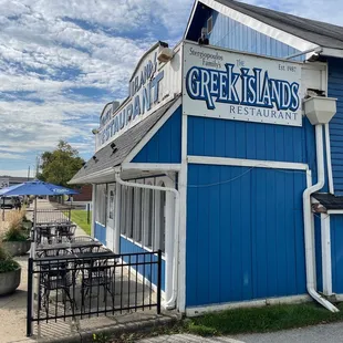 a blue building with a sign that says greek islands