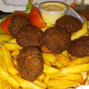 a platter of meatballs and fries