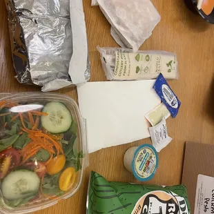 Sandwich, salad, chips, blonde, napkin, dressing, mustard, mayonnaise, hand wipe, napkins, utensils