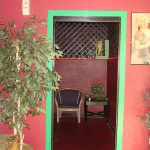 a room with a red wall and a green door