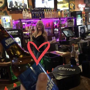 a woman holding a bottle of beer