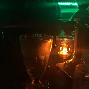 a candle and glasses on a table