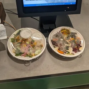 two bowls of food in front of a computer