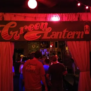 a group of people standing under a sign