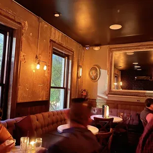 people sitting at tables in a restaurant