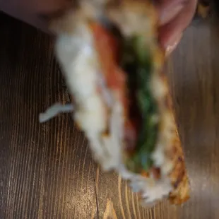 a person holding a sandwich