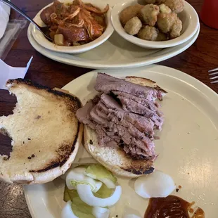 Sliced brisket sandwich, okra and jambalaya sides.