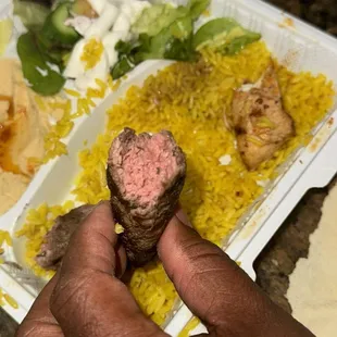 a person holding a piece of food