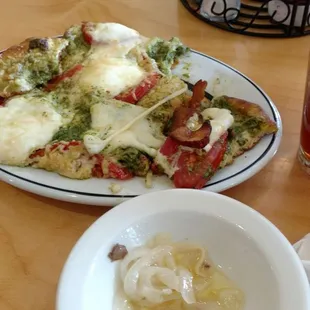 Gross flat bread that was inedible and overly cheesed. Tomatoes were soggy and unappetizing, tasted like gas station food. Chunks of cheese.