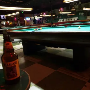 a pool table and a beer