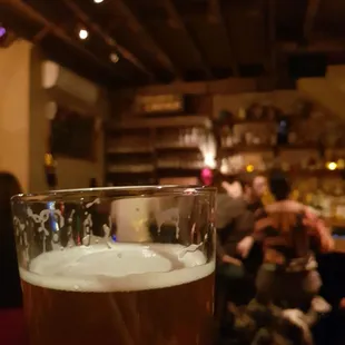 a person holding a glass of beer