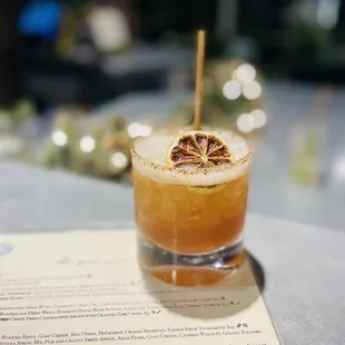 a cocktail with a slice of lemon