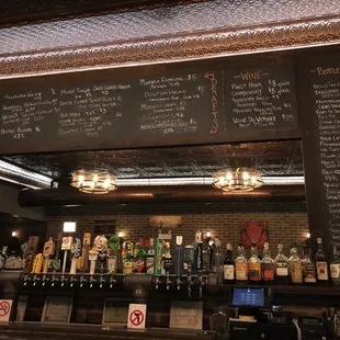 a bar with a menu on the wall