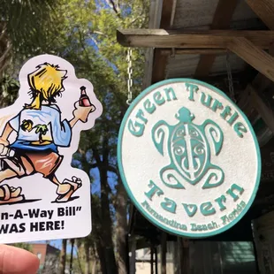 a person holding a sticker