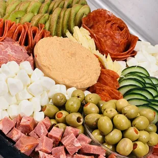 a platter of meats and vegetables