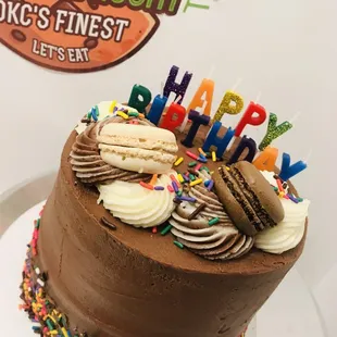 a chocolate cake with frosting and sprinkles