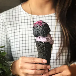 Purple on black on purple on black. Rose crystals on top of black ash coconut on top of ube on top of a black ash cone!