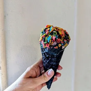 Coconut ash flavor in black cone with fruity pebbles topping