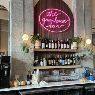 a neon sign above the bar
