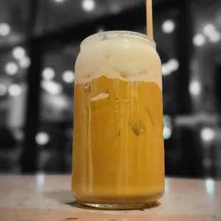 a glass of beer with a straw