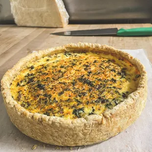 A house made quiche.  Available whole or by the slice.  Seasonal flavors!