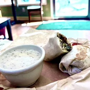 Potato, eggs &amp; cheese Breakfast burrito with a side of gravy