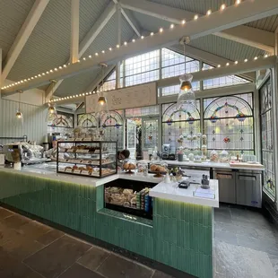 the interior of a cafe with a long counter
