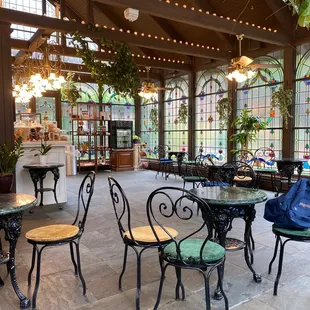 tables and chairs in a greenhouse