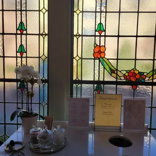 two stained glass windows and a table
