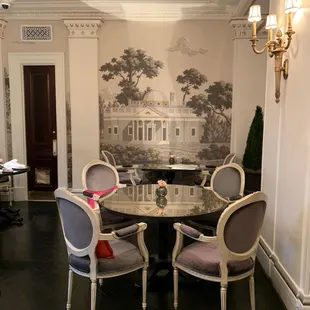 a dining room with a table and chairs