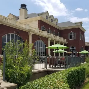 a patio with tables and umbrellas