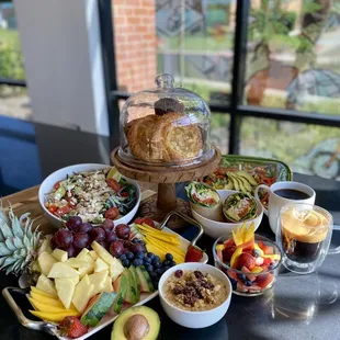 a platter of fruit, bread, and other foods