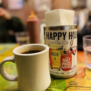 a cup of coffee and a can of beer