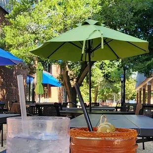 two drinks on a table with umbrellas