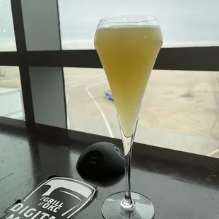 Enjoying a cocktail and watching the planes. They have phone charger hookup available.