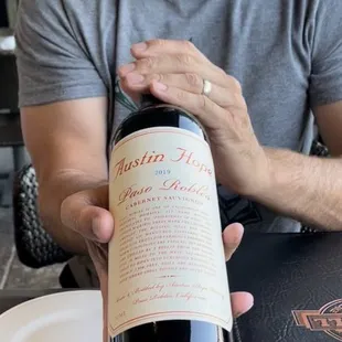 a man holding a bottle of wine