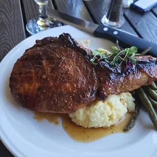 a steak and mashed potatoes on a plate