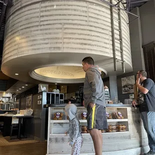 a man and a child standing in front of a counter