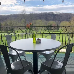 Outdoor Seating on the covered balcony with beautiful views of the golf course and the river in the distance