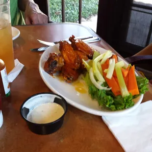 Spicy chicken wings with carrots and celery and ranch dressing