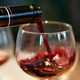 a glass of wine being poured