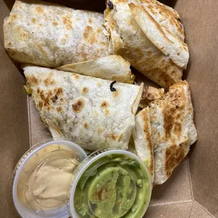 Chicken quesadilla with spicy queso and guacamole